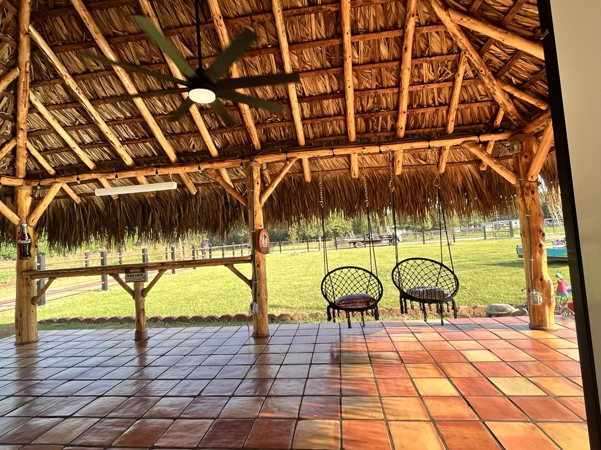 Custom thatched palapa with cedar posts in a North Texas backyard