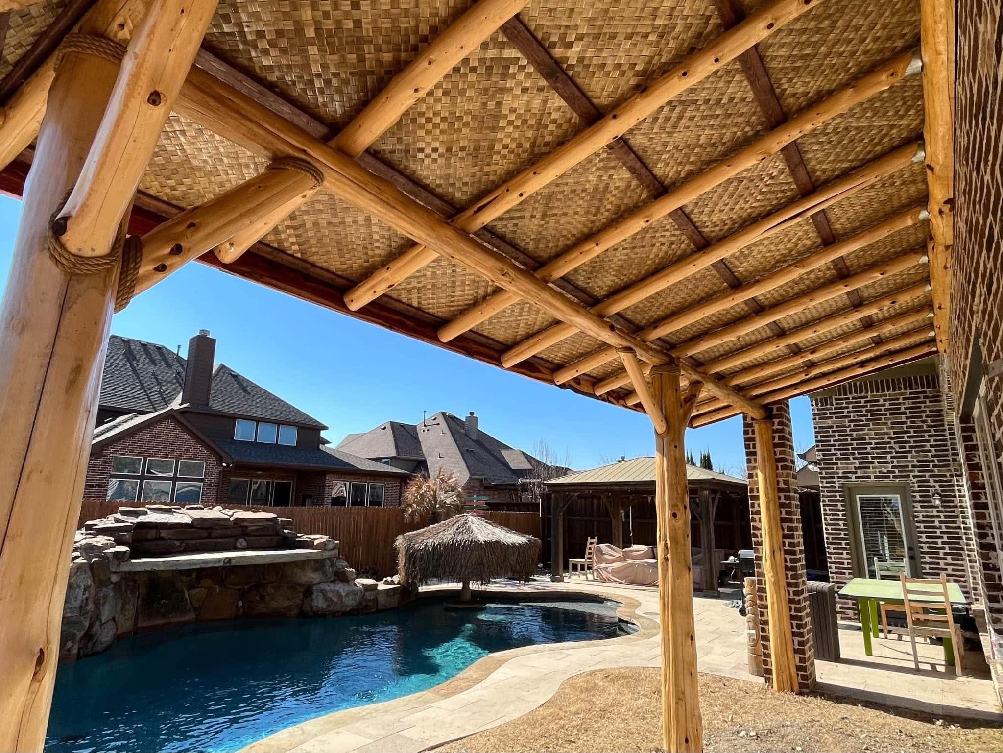 Custom cedar pergola over an outdoor kitchen and dining area